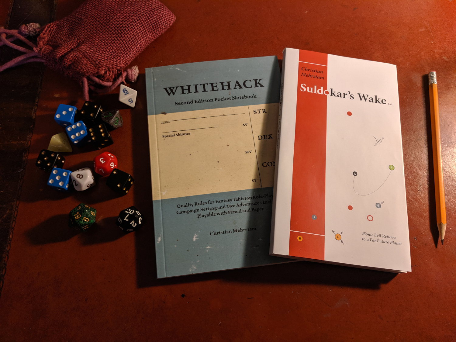 image of Suldokar’s Wake next to Whitehack Pocket Edition and some dice